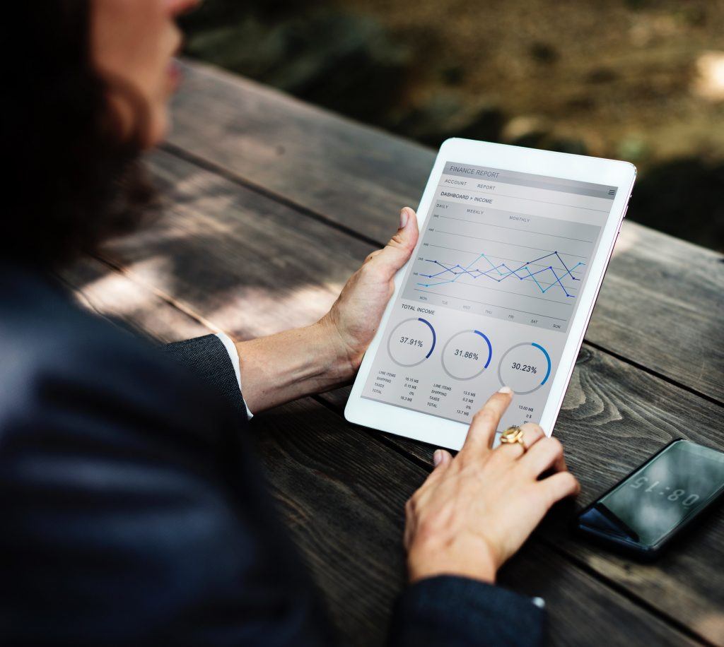 Businesswoman using tablet to look at graphs and stats